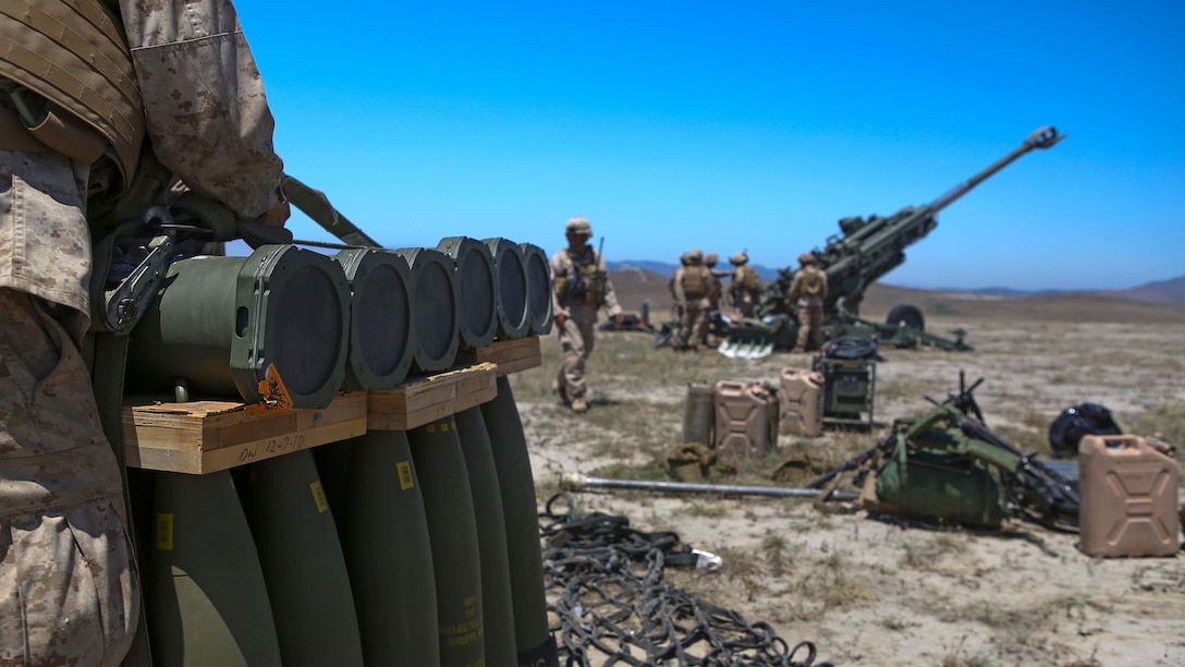 Marines assigned to Combat Logistics Battalion 13, Headquarters Regiment, 1st Marine Logistics Group, prepare ammunition to be fired after it was delivered by CH-53E Super Stallions at Marine Corps Base Camp Pendleton, California June 17, 2015. The CH-53s transported M777 howitzers and ammunition as part of 1st Battalion, 11th Marine Regiment’s quarterly exercise to test the artillery Marines’ proficiency and readiness.