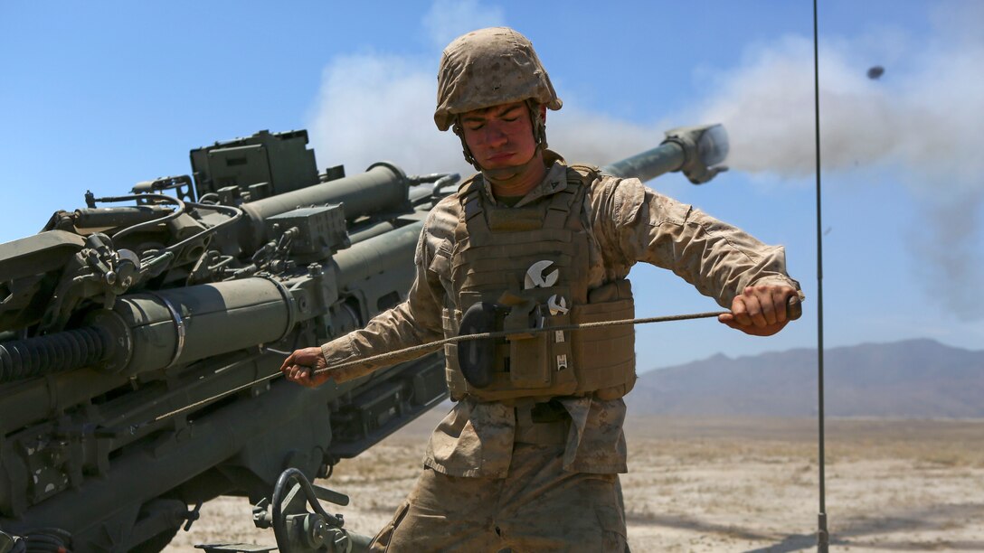Lance Corporal Jarrett Ready, an artillery mechanic assigned to Company A, 1st Battalion, 11th Marine Regiment, 1st Marine Division, fires an M777 howitzer at Marine Corps Base Camp Pendleton, June 17, 2015. CH-53E Super Stallions transported howitzers and ammunition as part of 1/11’s quarterly exercise to test the artillery Marines’ proficiency and readiness for any scenario.