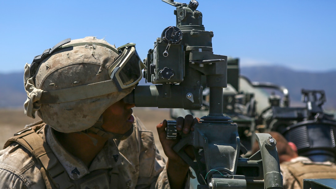 A Marine assigned to Company A, 1st Battalion, 11th Marine Regiment, 1st Marine Division, prepares an M777 howitzer to fire, at Marine Corps Base Camp Pendleton, June 17, 2015. CH-53E Super Stallions transported howitzers and ammunition as part of 1/11’s quarterly exercise to test the artillery Marines’ proficiency and readiness.