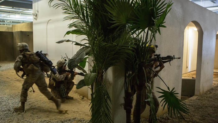 Marines with Bravo Company, 2nd Combat Engineer Battalion, simulate returning fire during the Infantry Immersion Trainer at Marine Corps Base Camp Lejeune, North Carolina, June 17, 2015. Marines were able to practice tactics, communication within the unit and combat readiness in a realistic training scenario, which better prepared them for a deployed environment. 