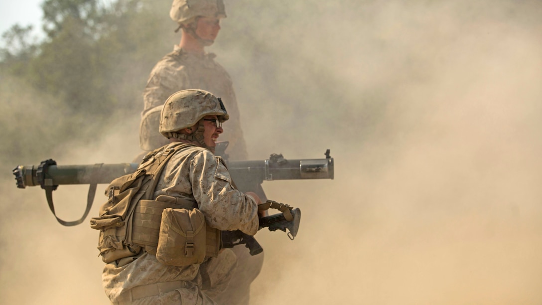 Lance Cpl. Andrew McGee, from Baton Rouge, Louisiana, watches the impact of the 83 mm rocket that Lance Cpl. Dakota Zacheis, from Trenton, New Jersey, fired from a Shoulder-Launched, Multipurpose Assault Weapon June 7 at Rodriguez Live Fire Complex, Republic of Korea, during Korean Marine Exchange Program 15-19. The SMAW is an 83 mm man-portable weapon system. It was designed to destroy bunkers and other fortifications during assault operations and to destroy main battle tanks with the High Explosive Anti-Armor rocket. The exercise allows the battalion to maintain readiness and build the mutual strength and friendship between the ROK Marine Corps and U.S. Marine Corps. Both Marines are infantry assault men with Kilo Company, 3rd Battalion, 2nd Marine Regiment, 3rd Marine Division, III Marine Expeditionary Force.