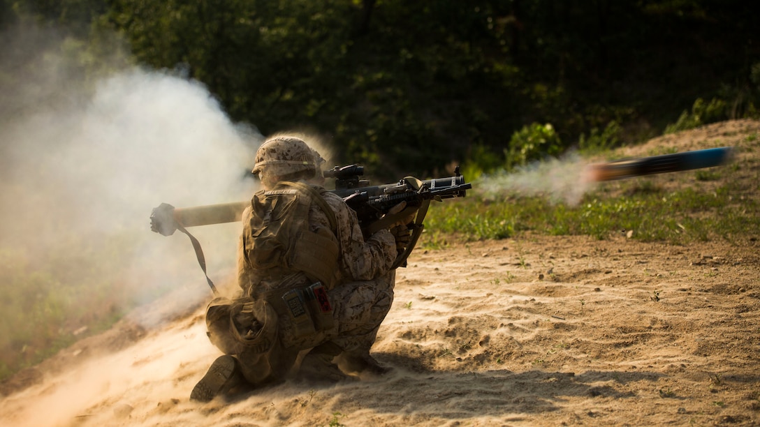 Lance Cpl. Corey Teubert, from Liberty, Kentucky, braces himself as Cpl. Evan Ouellette, from Cornish, Maine, fires a Shoulder-Launched, Multipurpose Assault Weapon June 7, at Rodriguez Live Fire Complex, Republic of Korea, during Korean Marine Exchange Program 15-19. The SMAW is an 83 mm man-portable weapon system. It was designed to destroy bunkers and other fortifications during assault operations and to destroy main battle tanks with the High Explosive Anti-Armor rocket. This exercise allows the battalion to maintain readiness and build the mutual strength and friendship between the ROK Marine Corps and U.S. Marine Corps. Both Marines are infantry assault men with Company L, 3rd Battalion, 2nd Marine Regiment, 3rd Marine Division, III Marine Expeditionary Force.