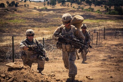 A squad from Company A, 1st Battalion,160th Infantry Regiment moves up to help secure the objective during a platoon attack live-fire exercise at Fort Hunter Liggett, California. The exercise tested the ability of the unit to fire and maneuver on an objective to accomplish one of the core mission of the Infantry.