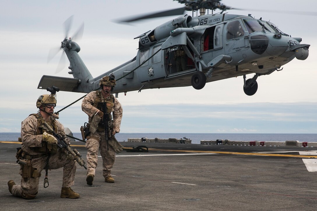 U.S. Marines with the 15th Marine Expeditionary Unit’s Maritime Raid Force fast-rope out of an MH-60S Seahawk onto the flight deck of the USS Essex (LHD 2) at sea in the Indian Ocean, June 16, 2015. These Marines sustain their fast-rope skills frequently to ensure they are capable of safely and rapidly inserting onto an objective from helicopters. (U.S. Marine Corps photo by Cpl. Anna Albrecht/Released)