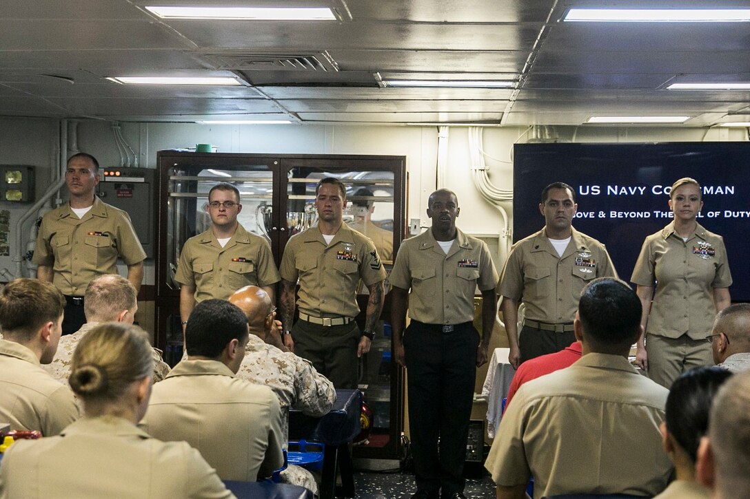 U.S. Sailors and Marines with the Essex Amphibious Ready Group and 15th Marine Expeditionary Unit join to celebrate the Hospital Corps’ 117th birthday aboard the USS Essex (LHD 2) at sea in the Indian Ocean, June 17, 2015. During the ceremony, hospital corpsmen spoke before their fellow Marines and Sailors about the importance of their job and why they chose the path to serve their country as a corpsman. (U.S. Marine Corps photo by Cpl. Anna Albrecht/ Released)