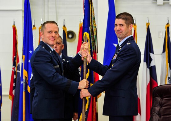 Brig. Gen. John A. Cherrey, Air Education and Training Command director of intelligence, operations and nuclear integration, passes the 33rd Fighter Wing flag to Col. Lance Pilch during a change of command ceremony, June 19, 2015, on Eglin Air Force Base, Florida. Col. Pilch assumed command of the 33 FW from Col. Todd D. Canterbury. (U.S. Air Force photo/Staff Sgt. Marleah Robertson)