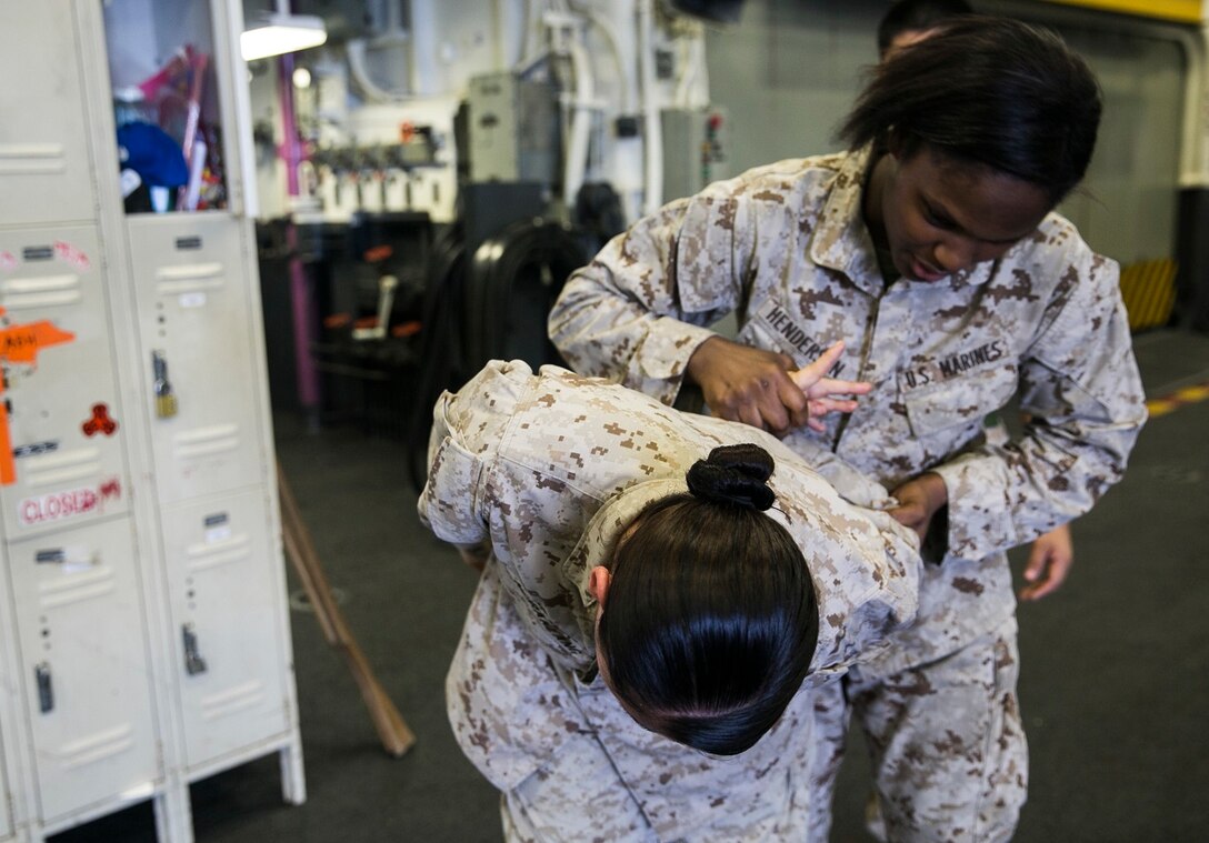 U.S. Marine Lance Cpl. Lashawna Henderson, right, practices a counter move on Lance Cpl. Cristina Ngraklang during Marine Corps Martial Arts Program aboard the USS Essex (LHD 2) at sea in the Indian Ocean, June 18, 2015. Henderson is a food-service specialist with Marine Medium Tiltrotor Squadron 161 (Reinforced), 15th Marine Expeditionary Unit, and Ngiraklang is a food-service specialist with Combat Logistics Battalion 15, 15th MEU. MCMAP develops the Marine’s hand-to-hand combat skills, enhancing their combat-readiness while deployed. (U.S. Marine Corps photo by Cpl. Anna Albrecht/ Released)