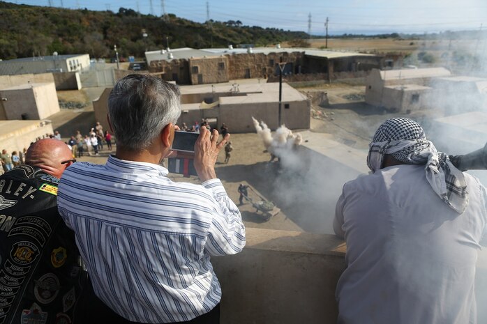 Local community leaders are given an authentic look at a notional insurgent attack at the Infantry Immersion Training Facility aboard Marine Corps Base Camp Pendleton, Calif., June 13, 2015. The guests were given an opportunity to see the training and atmosphere the Marines may experience when deployed.