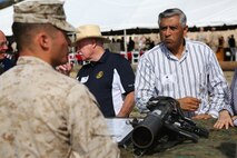 Marines with the 1st Marine Division explain the capabilities of different weapon systems and gear they use to community leaders from across Southern California aboard Marine Corps Base Camp Pendleton, Calif., June 13, 2015. The guests were given an opportunity to experience the training and atmosphere the Marines and Sailors endure on deployment through a demonstration at the Infantry Immersion Training Facility.