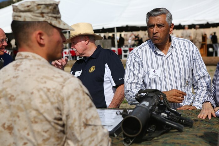 Marines with the 1st Marine Division explain the capabilities of different weapon systems and gear they use to community leaders from across Southern California aboard Marine Corps Base Camp Pendleton, Calif., June 13, 2015. The guests were given an opportunity to experience the training and atmosphere the Marines and Sailors endure on deployment through a demonstration at the Infantry Immersion Training Facility.