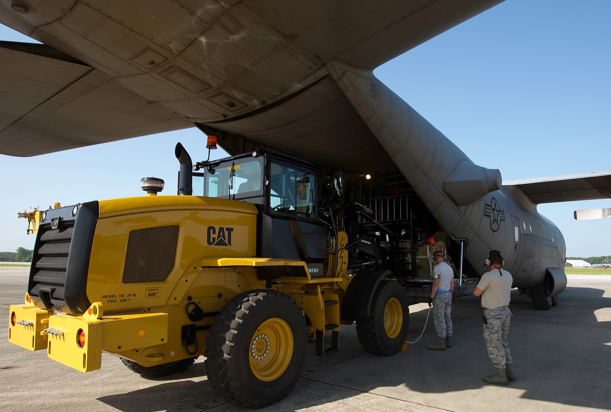 U.S. Air Force Tech. Sgt. Chris Giradeau (left), 81st Aerial Port Squadron Port Dawg Challenge participant, observes the forklift movements during a engine running onload and offload challenge at Dobbins Air Reserve Base, Ga., June 16, 2015. The Port Dawg Challenge was created to enhance and maintain the camaraderie, esprit de corps and prestige of aerial port Airmen while promoting professionalism, leadership, training and communication between "Port Dawgs." (U.S. Air Force photo by Senior Airman Josh Slavin/Released)