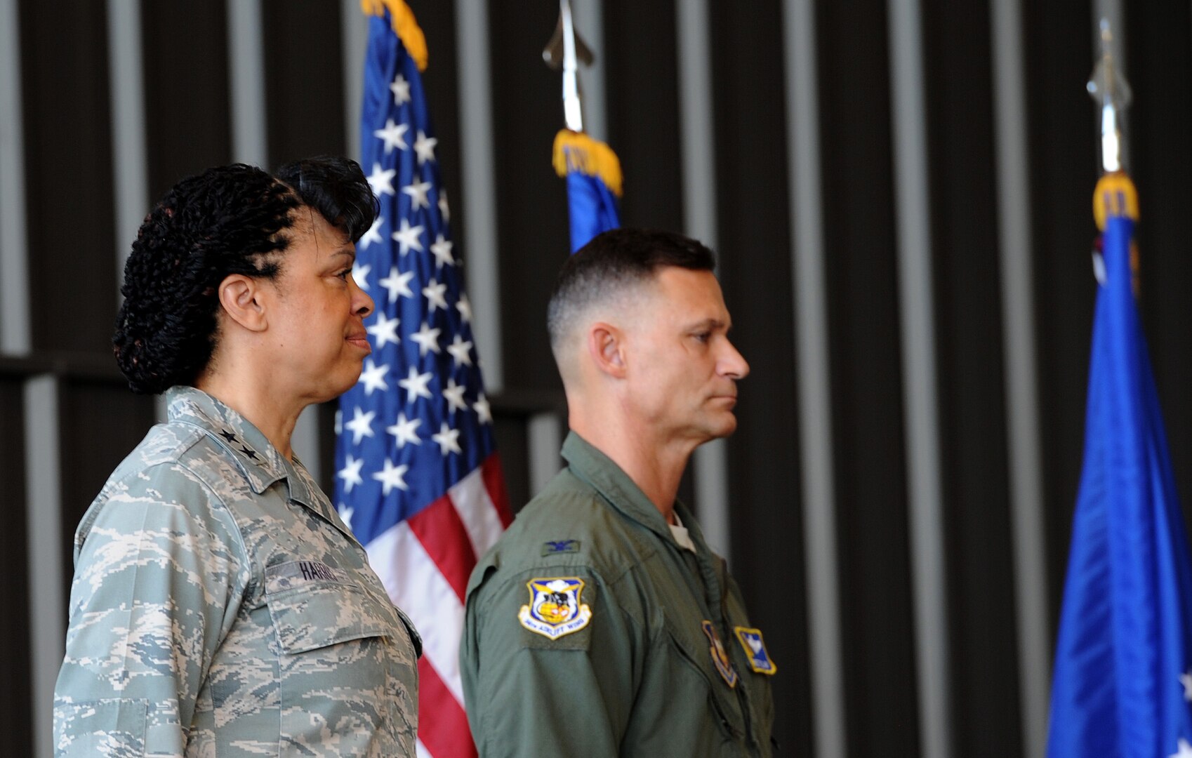 U.S. Air Force Maj. Gen. Stayce Harris (left), 22nd Air Force commander, and Col. Brett Clark, 94th Airlift Wing commander, stand at attention while the national anthem plays during the opening ceremonies of the Port Dawg Challenge at Dobbins Air Reserve Base, Ga., June 16, 2015. The Port Dawg Challenge was created to enhance and maintain the camaraderie, esprit de corps and prestige of aerial port Airmen while promoting professionalism, leadership, training and communication between "Port Dawgs." (U.S. Air Force photo by Senior Airman Josh Slavin/Released)