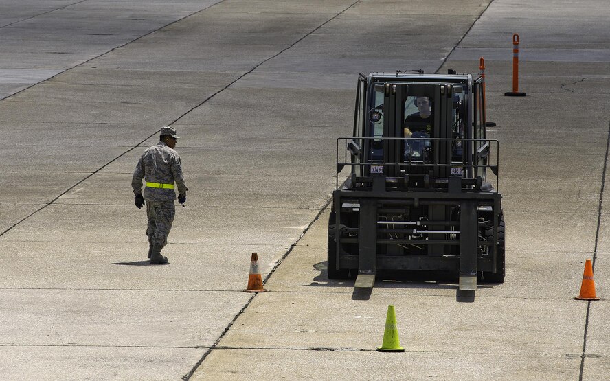 U.S. Air Force Tech. Sgt. Jefferey Dunlap, 32nd Aerial Port Squadron Port Dawg Challenge participant, maneuvers through cones during the 10K forklift course challenge at Dobbins Air Reserve Base, Ga., June 16, 2015. The Port Dawg Challenge was created to enhance and maintain the camaraderie, esprit de corps and prestige of aerial port Airmen while promoting professionalism, leadership, training and communication between "Port Dawgs." (U.S. Air Force photo by Senior Airman Josh Slavin/Released)