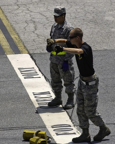 U.S. Air Force Tech. Sgt. Benjamin Reese, 32nd Aerial Port Squadron Port Dawg Challenge participant, provides directions to his partner while he competes in the 10K forklift course challenge at Dobbins Air Reserve Base, Ga., June 16, 2015. The Port Dawg Challenge was created to enhance and maintain the camaraderie, esprit de corps and prestige of aerial port Airmen while promoting professionalism, leadership, training and communication between "Port Dawgs." (U.S. Air Force photo by Senior Airman Josh Slavin/Released)