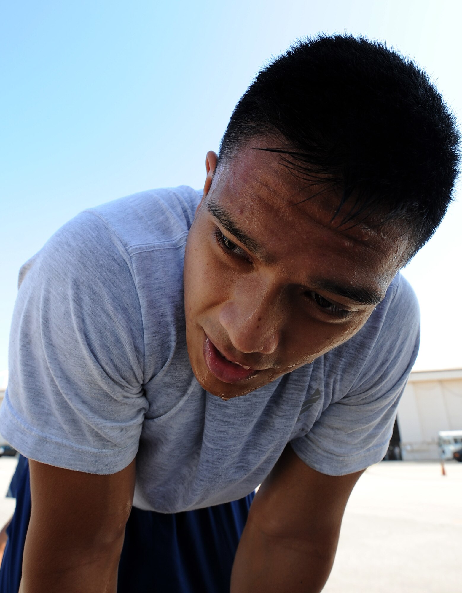 U.S. Air Force Senior Airman Matthew Mira, 44th Aerial Port Squadron, leans over to rest after finishing the fit to fight portion of the Port Dawg Challenge at Dobbins Air Reserve Base, Ga., June 17, 2015. The Port Dawg Challenge was created to enhance and maintain the camaraderie, esprit de corps and prestige of aerial port Airmen while promoting professionalism, leadership, training and communication between "Port Dawgs." (U.S. Air Force photo by Tech. Sgt. Stephen D. Schester/Released)