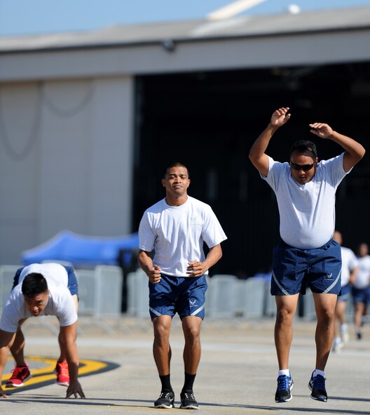 U.S. Air Force Senior Airman Matthew Mira, left, Staff Sgt. Harley Ngiratereged and Tech. Sgt. Tom Limitiaco, all assigned to the 44th Aerial Port Squadron, perform burpees during the fit to fight portion of the Port Dawg Challenge at Dobbins Air Reserve Base, Ga., June 17, 2015. The Port Dawg Challenge was created to enhance and maintain the camaraderie, esprit de corps and prestige of aerial port Airmen while promoting professionalism, leadership, training and communication between "Port Dawgs." (U.S. Air Force photo by Tech. Sgt. Stephen D. Schester/Released)