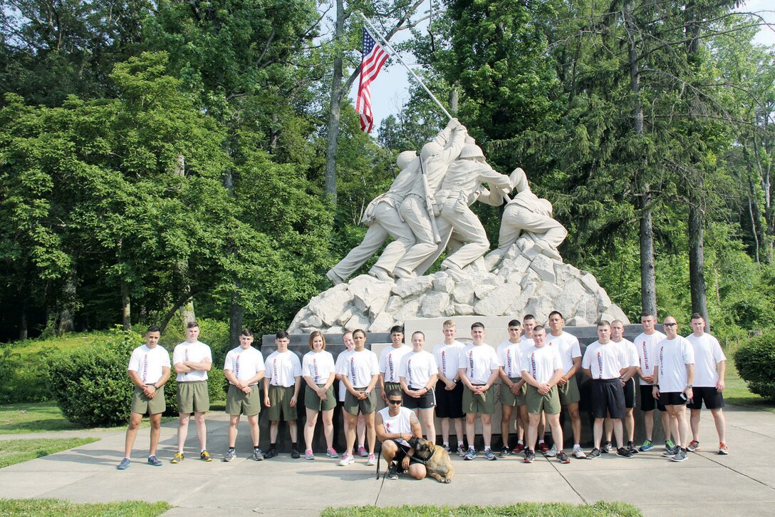 PMO officers and the K-9 unit pose in front of the Iwo Jima Memorial near US Route 1, June 11. The officers took part in the Law Enforcement torch run to raise awareness and funds for Special Olympics Virginia. 