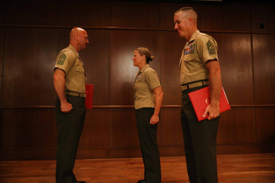 Commanding General of Force Headquarters Group, Marine Forces Reserve, Brig. Gen. Helen G. Pratt (middle), awards Sgt. Maj. Michael E. Sprague (left), with the Legion of Merit award as Sgt. Maj. William J. Grigsby (right), the new FHG sergeant major, stands by during Sprague’s retirement ceremony at Marine Corps Support Facility New Orleans, June 19, 2015. Sprague served as the first sergeant major of FHG, MFR, since June of 2012. (U.S. Marine Corps photo by Sgt. Brytani Musick)
