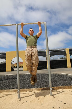 Private Ryley K. Absher, Lima Company, 3rd Recruit Training Battalion, performs pull ups for physical fitness training at Marine Corps Recruit Depot San Diego, June 15. Absher is a Snoqualmie, Wash., native and was recruited from Recruiting Station Seattle. Today, all males recruited west of the Mississippi are trained at MCRD San Diego. The depot is responsible for training more than 16,000 recruits annually. Lima Company graduated June 19.