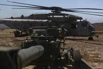 A CH-53E Super Stallion lands next to an M777 howitzer after delivering ammunition aboard Marine Corps Base Camp Pendleton, June 17, 2015. The CH-53Es transported M777 howitzers and ammunition as part of 1st Battalion, 11th Marine Regiment’s quarterly exercise to test the artillery Marines’ proficiency and readiness.