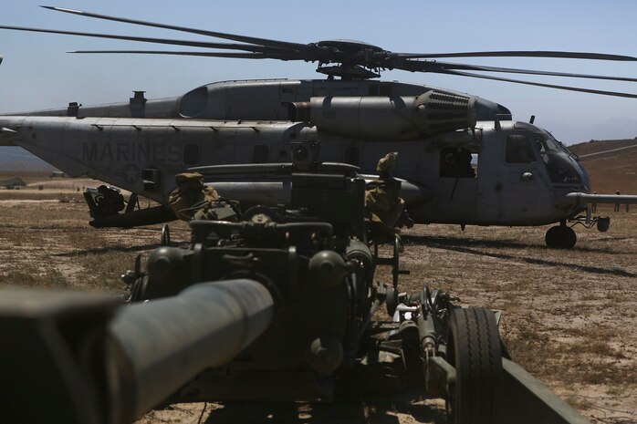 A CH-53E Super Stallion lands next to an M777 howitzer after delivering ammunition aboard Marine Corps Base Camp Pendleton, June 17, 2015. The CH-53Es transported M777 howitzers and ammunition as part of 1st Battalion, 11th Marine Regiment’s quarterly exercise to test the artillery Marines’ proficiency and readiness.