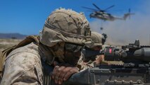 Corporal Kamen Pinkey, a motor transportation operator assigned to Company A, 1st Battalion, 11th Marine Regiment, 1st Marine Division, posts security for a CH-53E Super Stallion at Marine Corps Base Camp Pendleton, California, June 17, 2015. The CH-53s transported M777 howitzers and ammunition as part of 1/11’s quarterly exercise to test the artillery Marines’ proficiency and readiness.