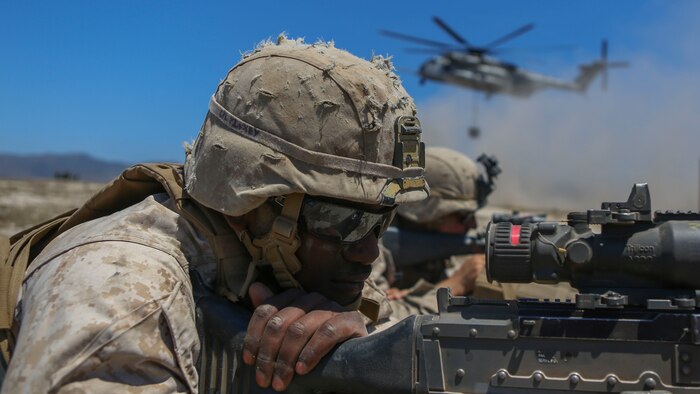 Corporal Kamen Pinkey, a motor transportation operator assigned to Company A, 1st Battalion, 11th Marine Regiment, 1st Marine Division, posts security for a CH-53E Super Stallion at Marine Corps Base Camp Pendleton, California, June 17, 2015. The CH-53s transported M777 howitzers and ammunition as part of 1/11’s quarterly exercise to test the artillery Marines’ proficiency and readiness.