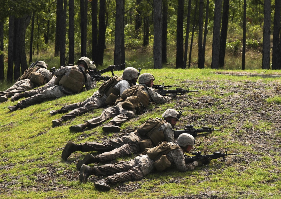 Marines with Bravo Company, 2nd Combat Engineer Battalion, take a defensive position during a live-fire and maneuver exercise at a range aboard Camp Lejeune, N.C., June 6, 2015. The training simulated the Marine’s response to encountering an enemy attack while on patrol. “If we work together in this training we’ll already know our plans, call signs and signals,” said Sgt. Christian Sampson, a combat engineer with the company. “We’ll have a plan laid out already so when we get in a fight we’ll know what to do.” (U.S. Marine Corps photo by Pfc. David N. Hersey/Released)