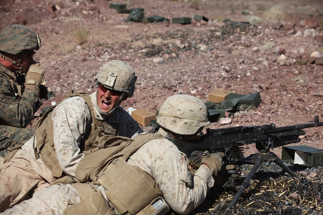 Lance Cpl. Rory Fuller, a machine gunner with 1st Battalion, 7th Marine Regiment, 1st Marine Division, I Marine Expeditionary Force, calls for his runner to bring additional ammunition during 1/7’s Marine Corps Combat Readiness Evaluation aboard Marine Corps Air Ground Combat Center Twentynine Palms, Calif., June 9, 2015.  Marines from 1/7 and 2nd battalion, 7th Marine Regiment are currently in preparation for deployment with the Special Purpose Marine Air Ground Task Force (SPMAGTF) scheduled to depart in support of Operation Inherent Resolve later this year.
