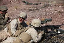 Lance Cpl. Rory Fuller, a machine gunner with 1st Battalion, 7th Marine Regiment, 1st Marine Division, I Marine Expeditionary Force, calls for his runner to bring additional ammunition during 1/7’s Marine Corps Combat Readiness Evaluation aboard Marine Corps Air Ground Combat Center Twentynine Palms, Calif., June 9, 2015.  Marines from 1/7 and 2nd battalion, 7th Marine Regiment are currently in preparation for deployment with the Special Purpose Marine Air Ground Task Force (SPMAGTF) scheduled to depart in support of Operation Inherent Resolve later this year.