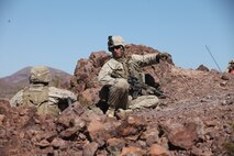 A sergeant with Company A, 1st Battalion, 7th Marine Regiment, 1st Marine Division, I Marine Expeditionary Force, directs his Marines into position atop a berm during 1/7’s Marine Corps Combat Readiness Evaluation aboard Twentynine Palms, Calif., June 9, 2015.  Marines from 1/7 and 2nd battalion, 7th Marine Regiment are currently in preparation for deployment with the Special Purpose Marine Air Ground Task Force (SPMAGTF) scheduled to depart in support of Operation Inherent Resolve later this year.