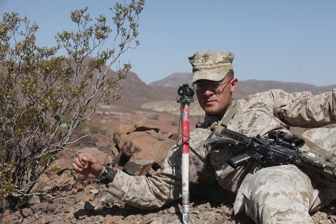 A mortarman with 1st Battalion, 7th Marine Regiment, 1st Marine Division, 1st Marine Expeditionary Force, establishes the direction of fires for his 60 millimeter mortar team during 1/7’s Marine Corps Combat Readiness Evaluation aboard Marine Corps Air Ground Combat Center Twentynine Palms, Calif., June 9, 2015.  Marines from 1/7 and 2nd battalion, 7th Marine Regiment are currently in preparation for deployment with the Special Purpose Marine Air Ground Task Force (SPMAGTF) scheduled to depart in support of Operation Inherent Resolve later this year.