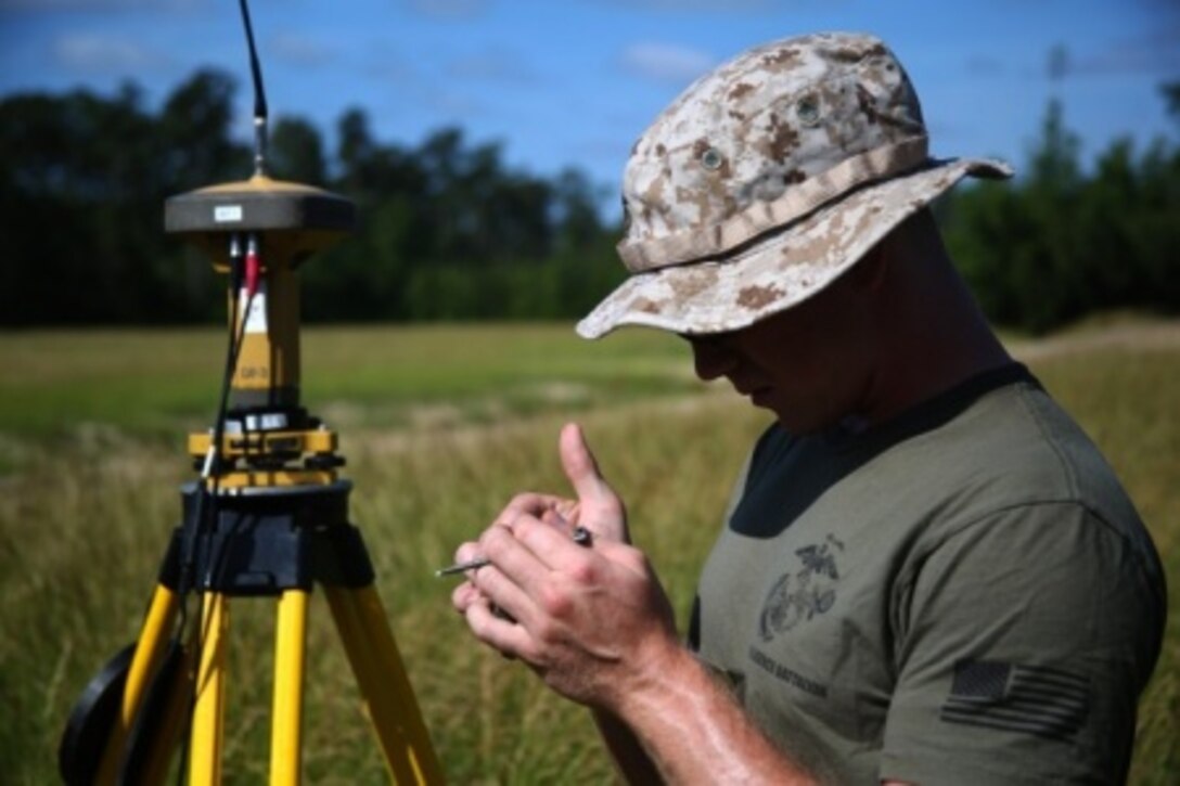 Private First Class Aaron Urbanski, a geographical intelligence specialist with Battlefield Surveillance Company, 2nd Intelligence Battalion, looks at data gathered by the base Global Positioning System during a geodetic survey of Landing Zone Lark aboard Camp Lejeune, North Carolina, May 28, 2015. Marines with the company are responsible for gathering information from each training area aboard Camp Lejeune, allowing pilots to determine whether the area is safe to land in or not.