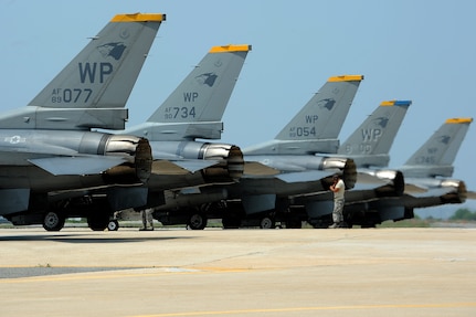 150618-F-ZP572-052 KUNSAN AIR BASE, Republic of Korea (June 18, 2015) F-16 Fighting Falcons line up on the runway before taking off during Surge Week at Kunsan Air Base, Republic of Korea, June 18, 2015. Surge Week tested the skills and wartime capabilities of Wolf Pack operators, maintainers and supporting agencies over a four-day window to simulate pilots' wartime flying rates. (U.S. Air Force photo by Senior Airman Divine Cox/Released)
