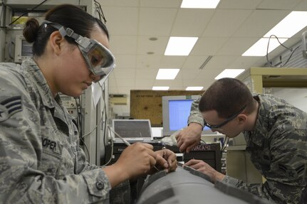 150526-F-VD309-056  EIELSON AIR FORCE BASE, Alaska (June 18, 2015) U.S. Air Force Senior Airman Elizabeth Looper and Airman 1st Class Corey Sanders, 354th Maintenance Squadron electronic warfare technicians, replace safety wire on an electronic attack pod May 26, 2015, at Eielson Air Force Base, Alaska. After each pod is thoroughly inspected and cleaned, Airmen from the avionics back shop ensure it is reassembled and quality checked. (U.S. Air Force photo by Senior Airman Ashley Nicole Taylor/Released)