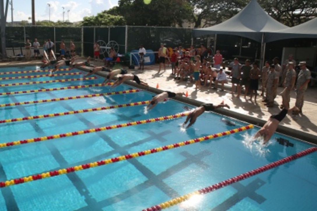 Swimmers dive into the pool for the 50-meter freestyle heat during the 101 Days of Summer swim meet on June 12 at the base pool aboard Marine Corps Base Hawaii. The purpose of 101 Days of Summer is to promote competition between units and responsible alcohol consumption and eliminating drug abuse. (U.S. Marine Corps photo by Cpl. Adam O. Korolev/ Released)


