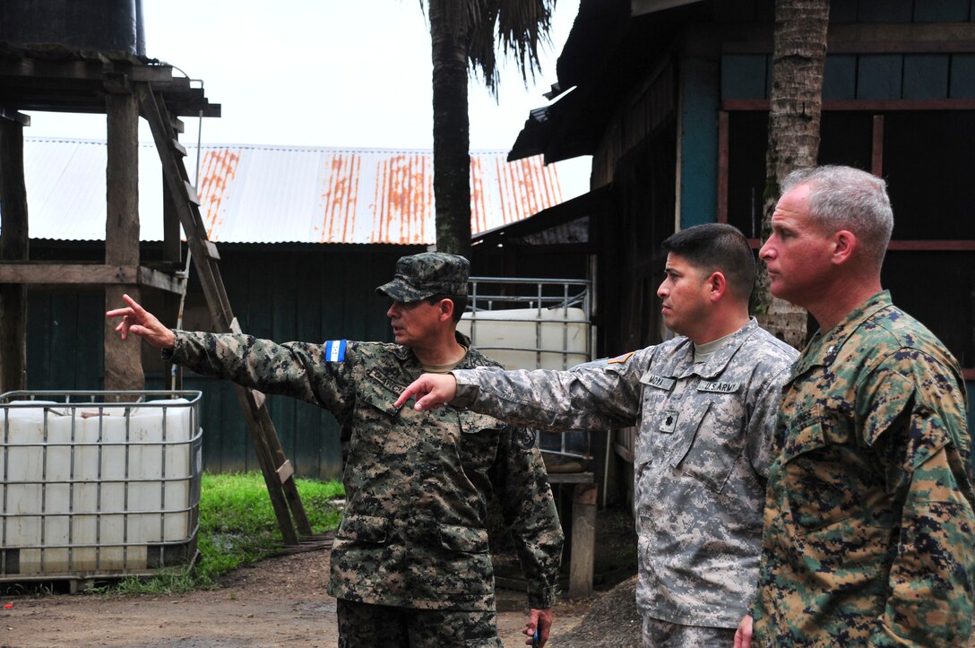 PUERTO LEMPIRA, Honduras – Honduran Army Col. Jose Garcia Maradiaga, Joint Task Force-Paz Garcia commander (left), gives U.S. Army Lt. Col. Carlos Moya, Joint Task Force-Bravo director of civil-military operations (center), and U.S. Marine Corps Lt. Col. David Hudak, Special Purpose Marine Air Ground Task Force-Southern Command commander (right), a tour of JTF-Paz Garcia June 18, 2015. The tour followed a meeting between SPMAGTF-SC, JTF-Bravo and Gracias a Dios leadership, to discuss the Marines’ upcoming construction projects in the department. (U.S. Air Force Photo by Capt. Christopher Love)