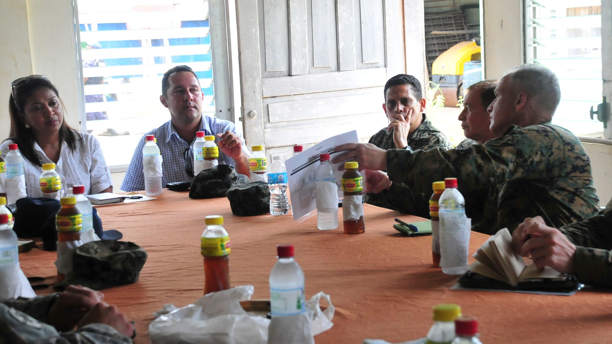 PUERTO LEMPIRA, Honduras – U.S. Marine Corps Lt. Col. David Hudak, Special Purpose Marine Air Ground Task Force-Southern Command commander, shows Gracias a Dios Department leaders the Marines’ plans to build a school in Puerto Lempira, Honduras, June 18, 2015. The Honduran delegation included the Ministry of Education representative for Gracias a Dios, Marelin Bendles (left), and the Governor of Gracias a Dios, Alberto Haylock (center left), among others. (U.S. Air Force Photo by Capt. Christopher Love)