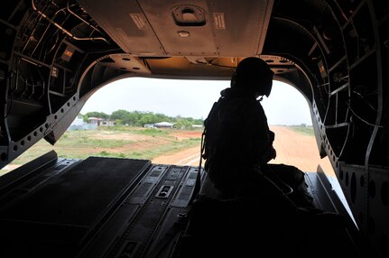 PUERTO LEMPIRA, Honduras – U.S. Army Sgt. Dane Rogge, 1-288th Aviation Regiment crew chief, watches from the back of a Ch-47 Chinook as it lands at the Puerto Lempira Airport, Honduras, June 18, 2015. Dane and the rest of the 1-228 crew enabled a bi-lateral visit between leaders from the Special Purpose Marine Air Ground Task Force-Southern Command and Joint Task Force-Bravo, both stationed at Soto Cano Air Base, Honduras, and leaders from the Gracias a Dios Department. (U.S. Air Force Photo by Capt. Christopher Love)