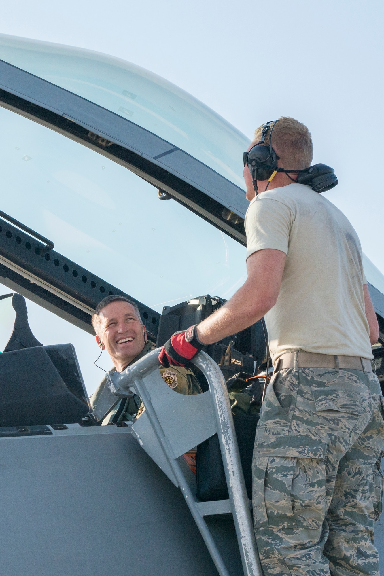 Senior Airman Craig Lively, 94th Aircraft Maintenance Unit Crew Chief, converses with Colonel Pat McAtee 192nd Fighter Wing Operations Group commander during Exercise Northern Edge 15 at JBER, Alaska, June 15, 2015. Pilots and maintainers from the 192nd Fighter Wing, Virginia Air National Guard and active duty Airmen from the 1st Fighter Wing, Joint Base Langley-Eustis are participating in the two-week training exercise. Northern Edge 2015 is Alaska’s premier joint training exercise designed to perfect mission operations, techniques and procedures as well as enhance interoperability across all military services, Reserves and Air National Guard forces. (U.S. Air Force photo by Staff Sgt. Jonathan Garcia/Released)