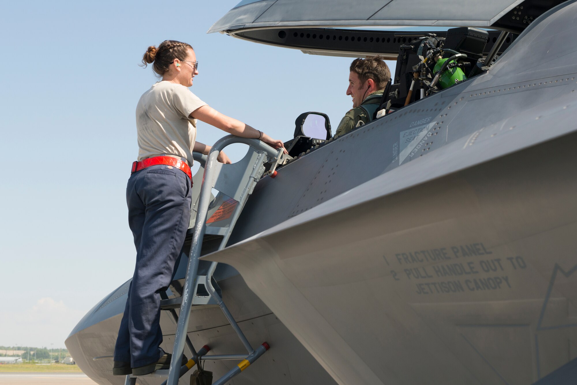 Senior Airman Sheila Smith, aircraft maintenance crew chief, 192nd Fighter Wing, Virginia Air National Guard, converses with an F-22 Raptor pilot during Exercise Northern Edge 15 at JBER, Alaska, June 15, 2015. Pilots and maintainers from the 192nd Fighter Wing, Virginia Air National Guard and active duty Airmen from the 1st Fighter Wing, Joint Base Langley-Eustis are participating in the two-week training exercise. Northern Edge 2015 is Alaska’s premier joint training exercise designed to perfect mission operations, techniques and procedures as well as enhance interoperability across all military services, Reserve and Air National Guard forces. (U.S. Air Force photo by Staff Sgt. Jonathan Garcia/Released)