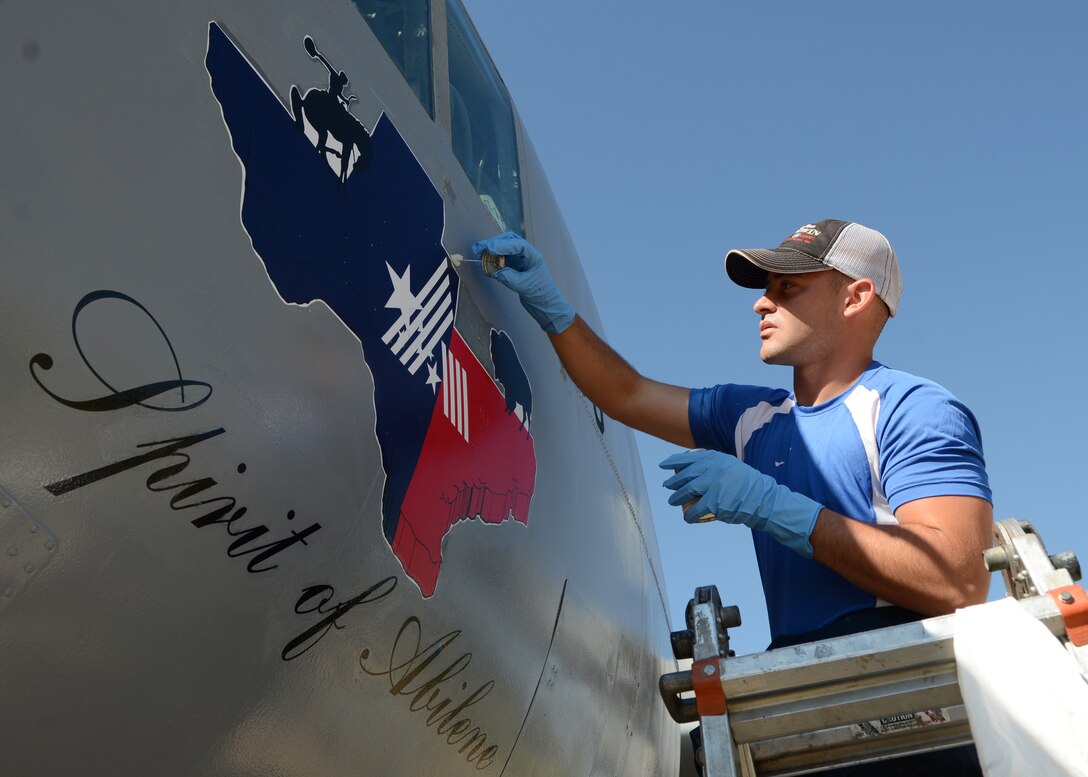 U.S. Air Force Airman 1st Class Jacob Wood, 7th Equipment Maintenance Squadron aircraft structural maintenance apprentice, applies edge sealer to the “Spirit of Abilene” decal on a C-130E Hercules June 11, 2015, at Dyess Air Force Base, Texas. The C-130E was among one of the 36 aircraft refurbished at the Dyess Linear Air Park this year as part of a major restoration project. (U.S. Air Force photo by Airman 1st Class Kedesha Pennant/Released)