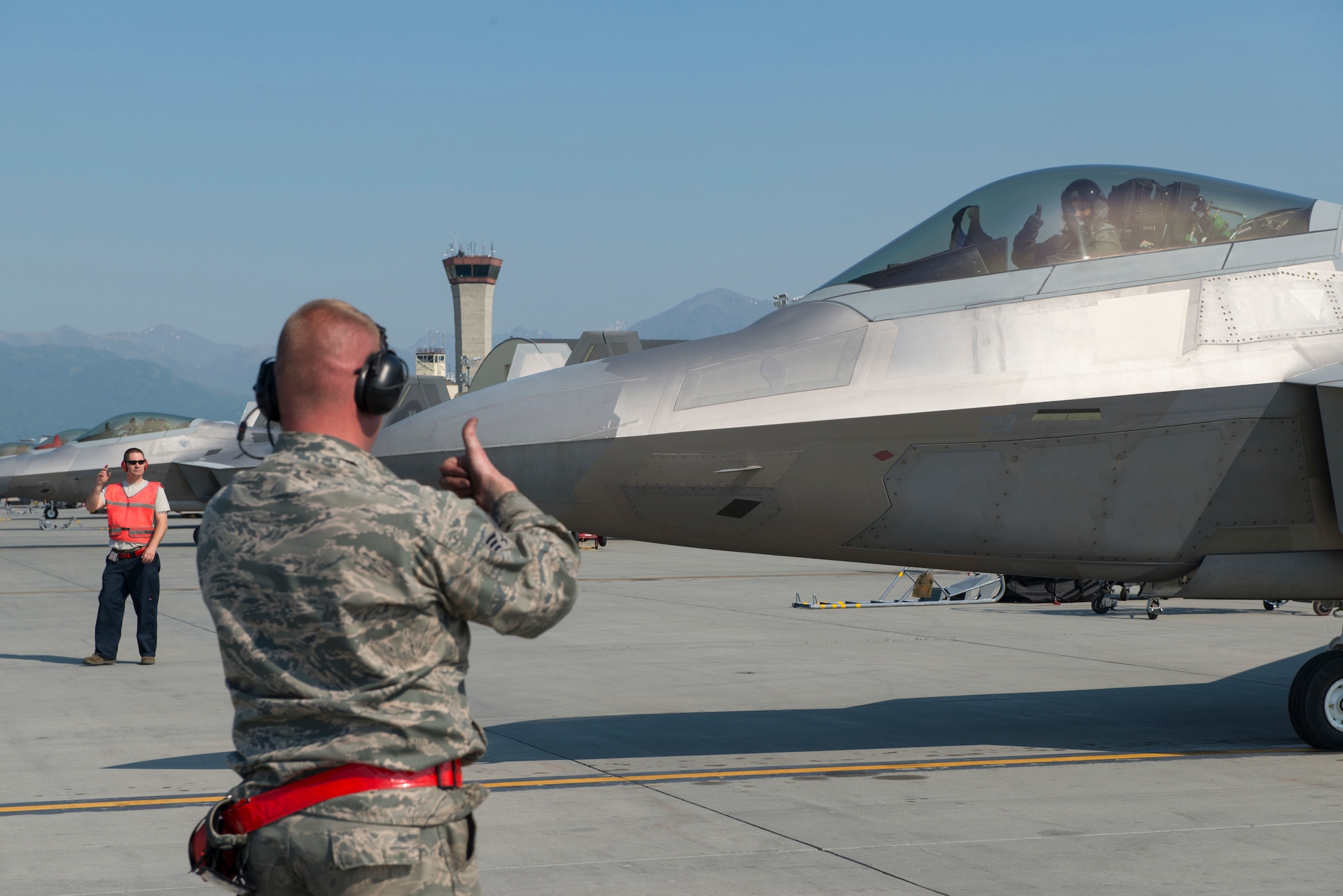 An F-22 pilot from the 149th Fighter Squadron, 192nd Fighter Wing, Virginia Air National Guard and his crew chief exchange thumbs-up confirming the jet is good to go for takeoff during Exercise Northern Edge 15 at JBER, Alaska, June 15, 2015. Northern Edge is Alaska’s premier joint training exercise, designed to perfect mission operations, techniques and procedures as well as enhance interoperability across all military branches, Reserve and Air National Guard forces. (U.S. Air Force photo by Staff Sgt. Jonathan Garcia/Released)