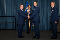 Col. Brian McDaniel, 92nd Air Refueling Wing commander, gives the 92nd Comptroller Squadron guidon to Lt. Col. Khalim Taha, 92nd CPTS new commander, during the 92nd CPTS change of command ceremony June 19, 2015, at Fairchild Air Force Base, Wash. Taha joins Team Fairchild from his previous position as the Air Staff Deputy Chief of Defense Research and Engineering and Procurement Division at the Pentagon, Virginia. (U.S. Air Force photo/Staff Sgt. Benjamin W. Stratton)