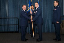 Col. Brian McDaniel, 92nd Air Refueling Wing commander, takes the 92nd Comptroller Squadron guidon from Maj. Kevin Watts, 92nd CPTS former commander, during the 92nd CPTS change of command ceremony June 19, 2015, at Fairchild Air Force Base, Wash. The change of command is an official, formal and brief ceremony that is the military’s way of bestowing command responsibility of a unit to an officer. (U.S. Air Force photo/Staff Sgt. Benjamin W. Stratton)