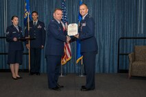 Col. Brian McDaniel, 92nd Air Refueling Wing commander, presents a Meritorious Service Medal to Maj. Kevin Watts, 92nd Comptroller Squadron former commander, during the 92nd CPTS change of command ceremony June 19, 2015, at Fairchild Air Force Base, Wash. The Meritorious Service Medal is a military award presented to members of the United States Armed Forces who distinguished themselves by outstanding meritorious achievement or service to the United States. (U.S. Air Force photo/Staff Sgt. Benjamin W. Stratton)