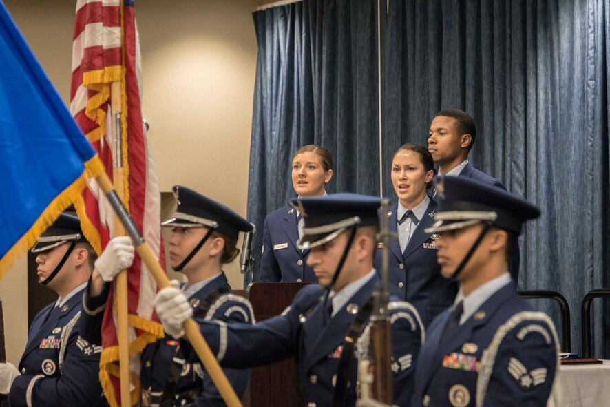 Senior Airmen Kimberly Carter and Stephanie George, 92nd Comptroller Squadron travel pay technicians, sing the national anthem as the Fairchild Honor Guard presents the colors during the 92nd CPTS change of command ceremony June 19, 2015, at Fairchild Air Force Base, Wash. The Star-Spangled Banner is the national anthem of the United States and has served in this capacity since a congressional resolution on March 3, 1931. Some historians note the song was also used officially by the U.S. Navy as early as 1889. (U.S. Air Force photo/Staff Sgt. Benjamin W. Stratton)