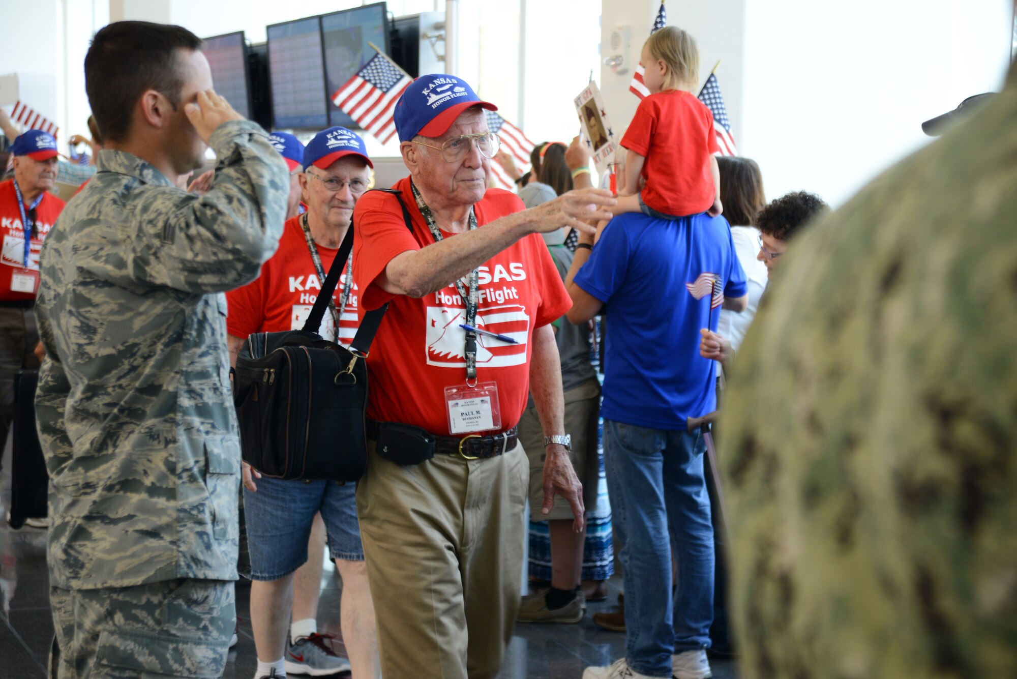 Team McConnell members and the local community welcome home World War II, Korean War and Vietnam War veterans after their trip with the 27th Kansas Honor Flight to and from Washington D.C., June 19, 2015, at the Wichita Dwight D. Eisenhower National Airport, Kan. The Kansas Honor Flight is a nonprofit organization that funds trips for veterans to visit war memorials created in their honor. (U.S. Air Force photos by Airman 1st Class Christopher Thornbury)