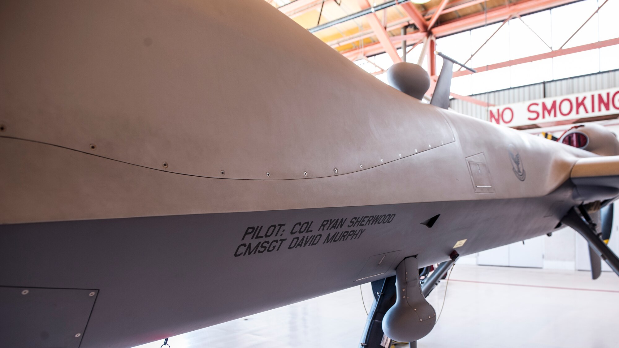 Col. Ryan Sherwood, incoming 49th Operations Group commander, has his name revealed on an MQ-1 Predator during the 49th OG Change of Command at Holloman Air Force Base, N.M., June 19, 2015. The 49th OG supports national security objectives by utilizing remotely piloted aircraft, and consists of the 49th Operations Support Squadron, the 6th Reconnaissance Squadron, the 29th Attack Squadron and the 9th Attack Squadron.  (U.S. Air Force photo by Airman 1st Class Emily A. Kenney/Released) 