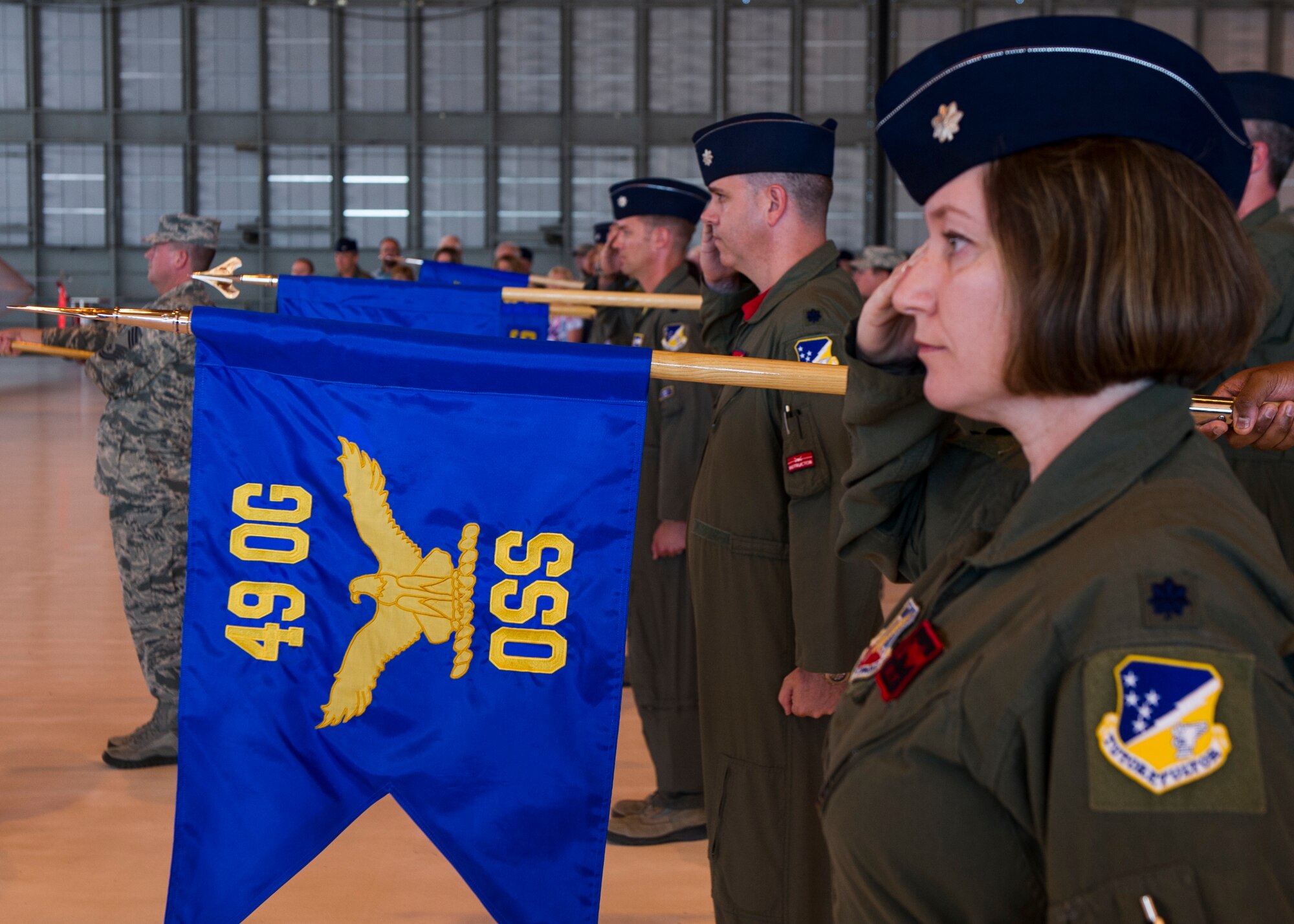 Squadron commanders within the 49th Operations Group salute during the National Anthem at the 49th OG Change of Command ceremony at Holloman Air Force Base, N.M., June 19, 2015. During the ceremony, Col. Mark Hoehn relinquished command of the 49th OG to Col. Ryan Sherwood. (U.S. Air Force photo by Airman 1st Class Emily A. Kenney/Released)